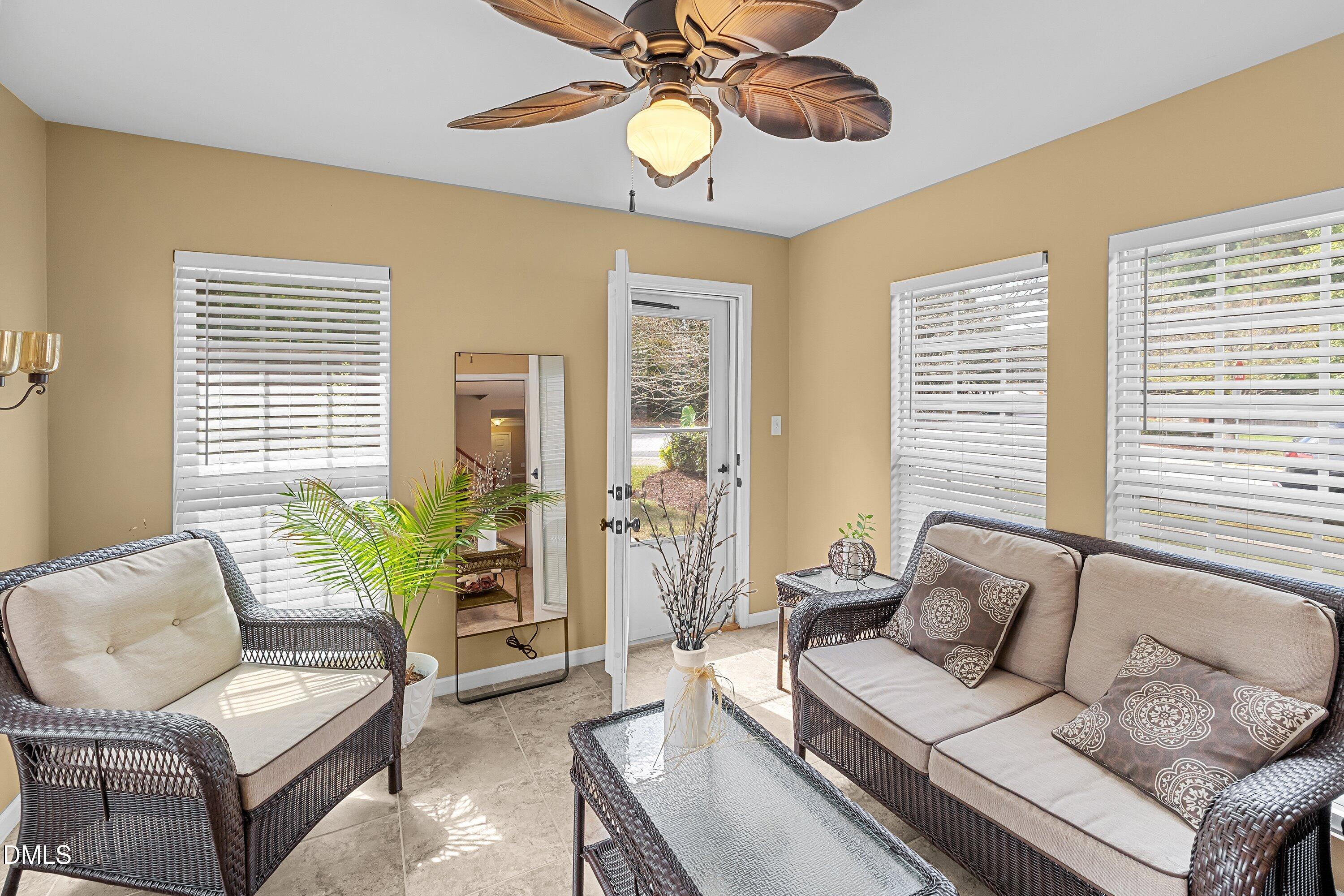 8911 Elizabeth Bennet Place Raleigh, NC 27616 - Photo 9 of 25 a living room with furniture a chandelier and a window
