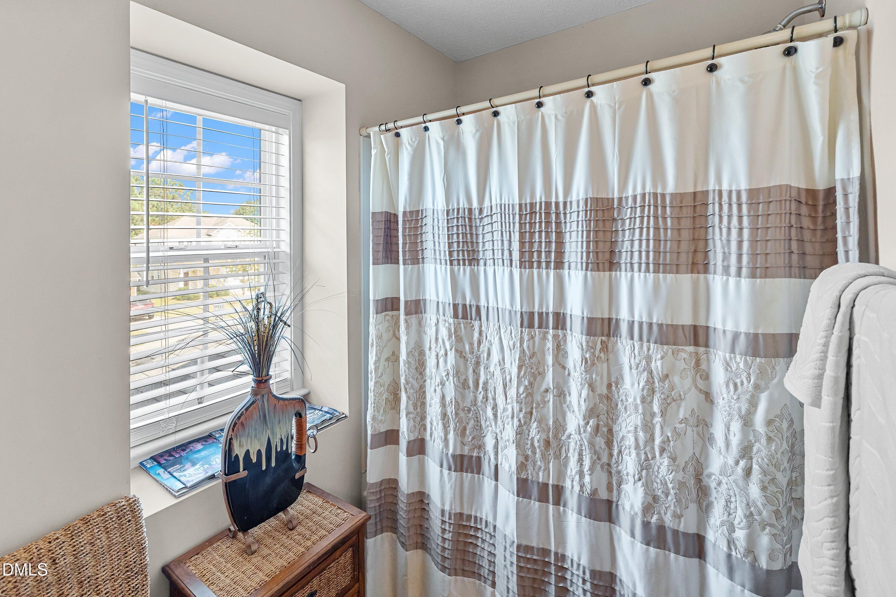 8911 Elizabeth Benneth Place Raleigh, NC 27616 - Photo 21 of 31 a view of a balcony with wooden floor and a couch