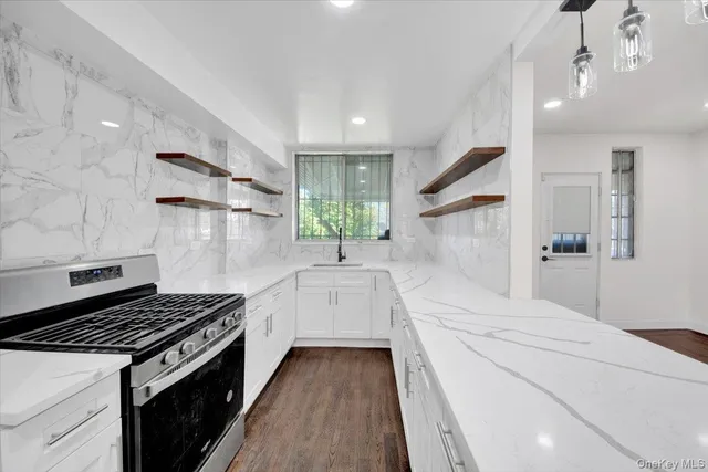 a kitchen with a stove and white cabinets