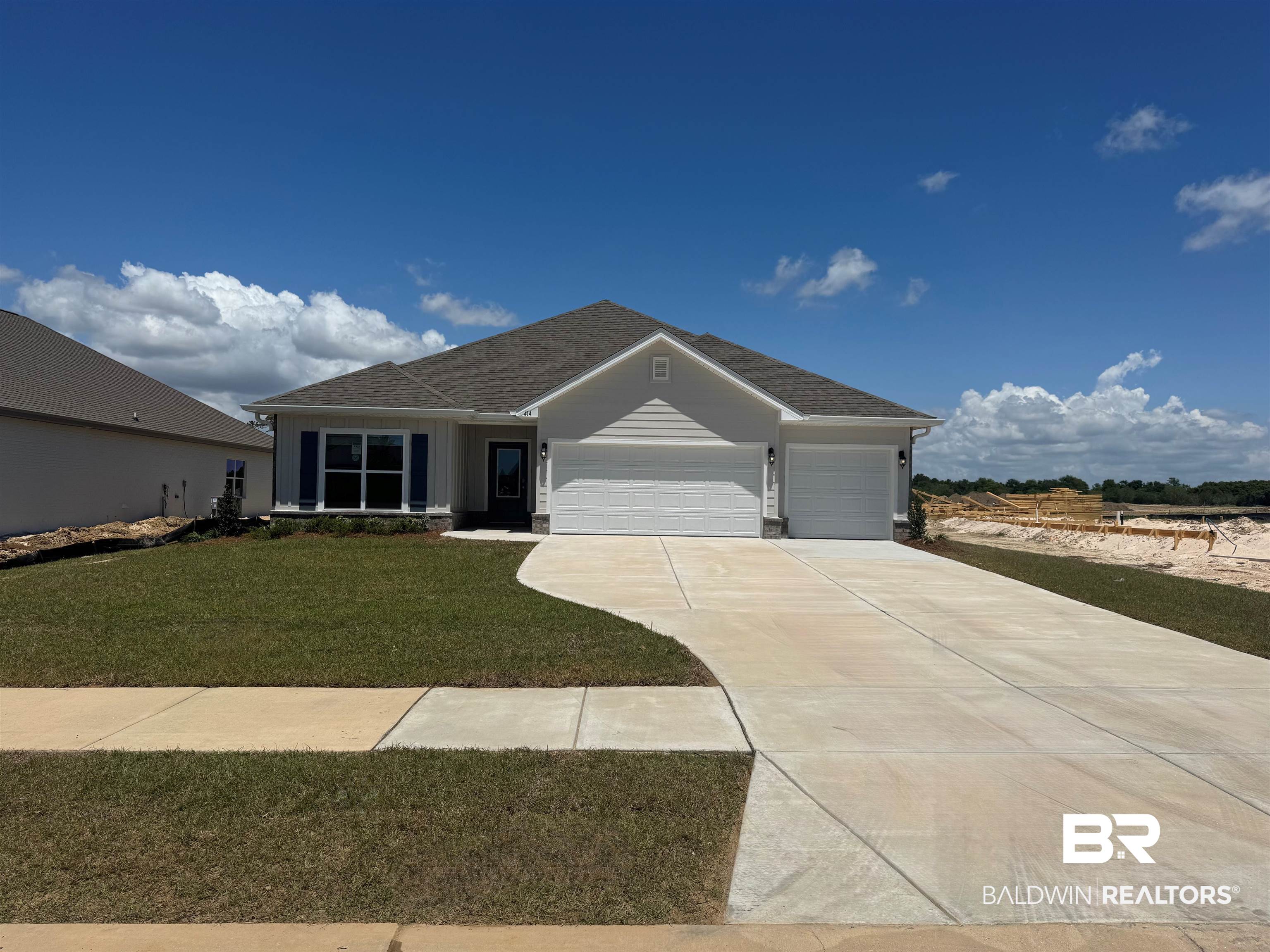 414 Raley Farms Drive Gulf Shores, AL 36542 - Photo 1 of 46 Single story home featuring a front lawn, a shingled roof, an attached garage, and concrete driveway