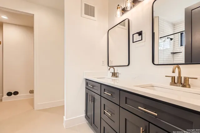a bathroom with a double vanity sink and a mirror