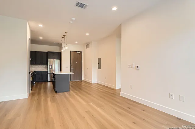 a view of kitchen with stainless steel appliances refrigerator microwave and stove