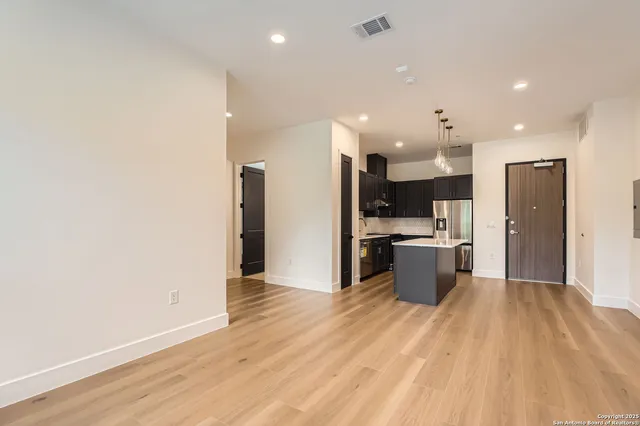 a large kitchen with a lot of counter space and stainless steel appliances