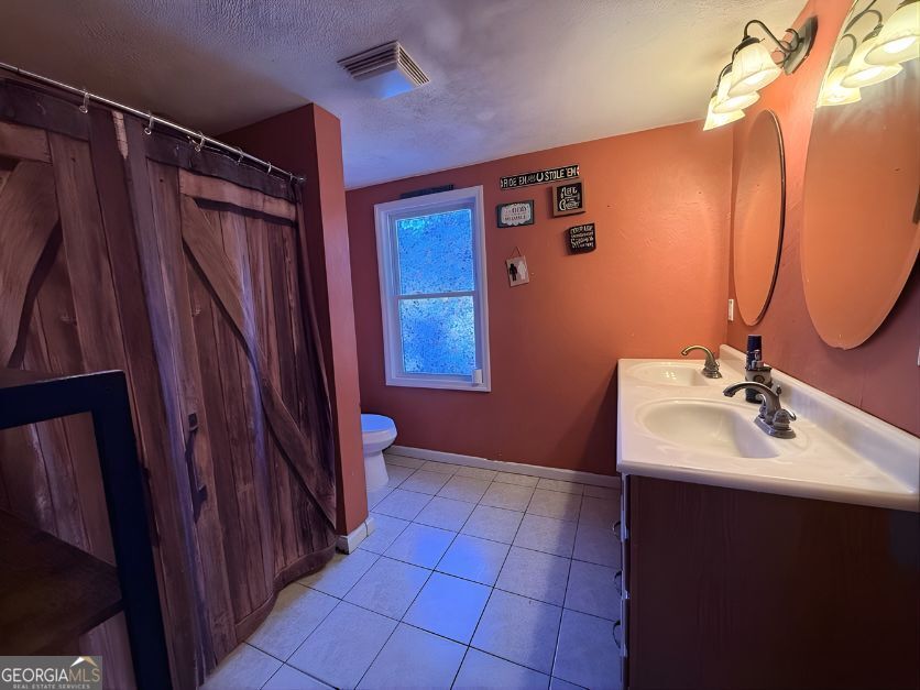 19963 Highway 46 Pembroke, GA 31321 - Photo 15 of 17 a bathroom with a sink a mirror and shower