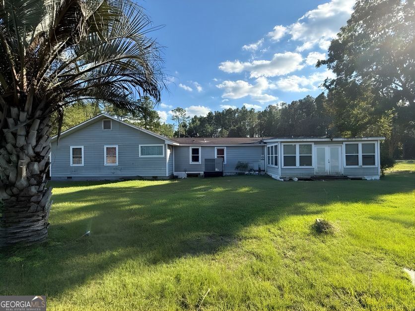 19963 Highway 46 Pembroke, GA 31321 - Photo 17 of 17 a front view of house with yard and swimming pool
