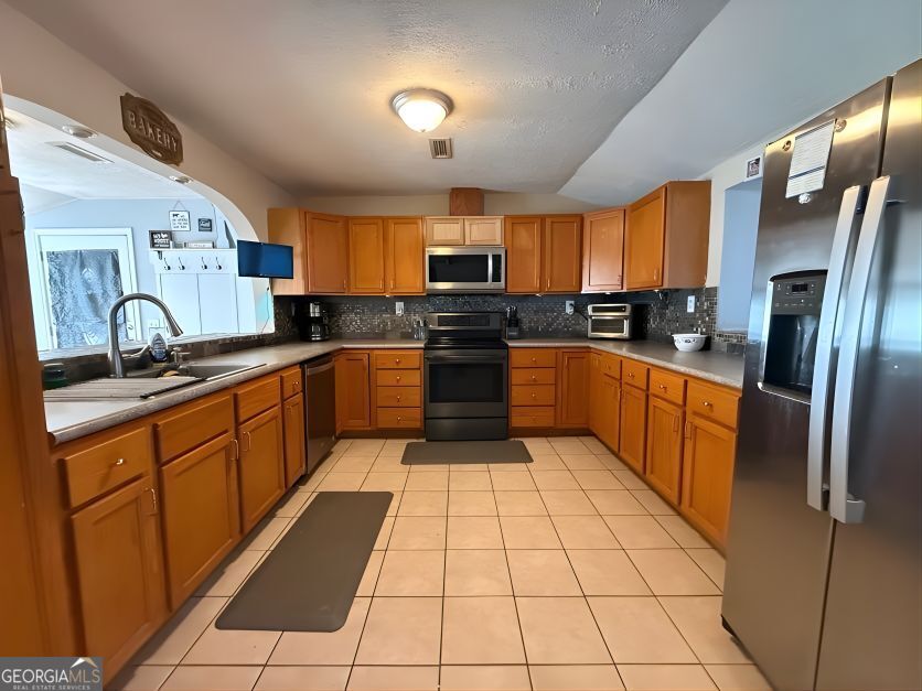 19963 Highway 46 Pembroke, GA 31321 - Photo 5 of 17 a large kitchen with stainless steel appliances granite countertop a stove sink and cabinets