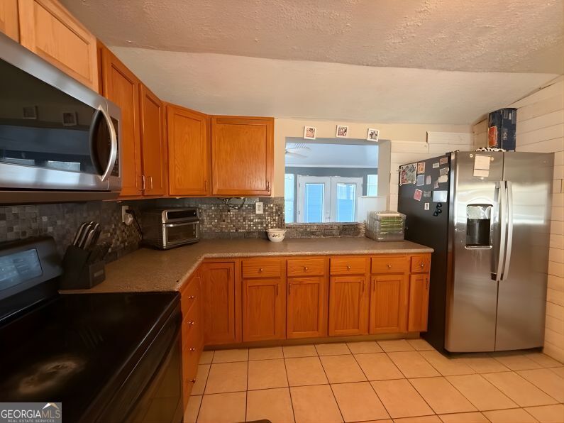 19963 Highway 46 Pembroke, GA 31321 - Photo 6 of 17 a kitchen with stainless steel appliances granite countertop a refrigerator and a stove top oven