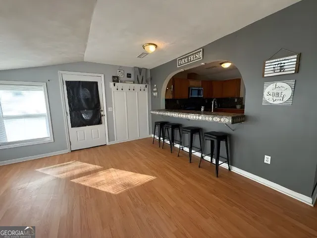 a view of livingroom with hardwood floor and workspace