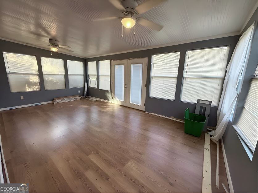 19963 Highway 46 Pembroke, GA 31321 - Photo 9 of 17 wooden floor in an empty room with a window