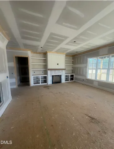 an empty room with furniture and a fireplace