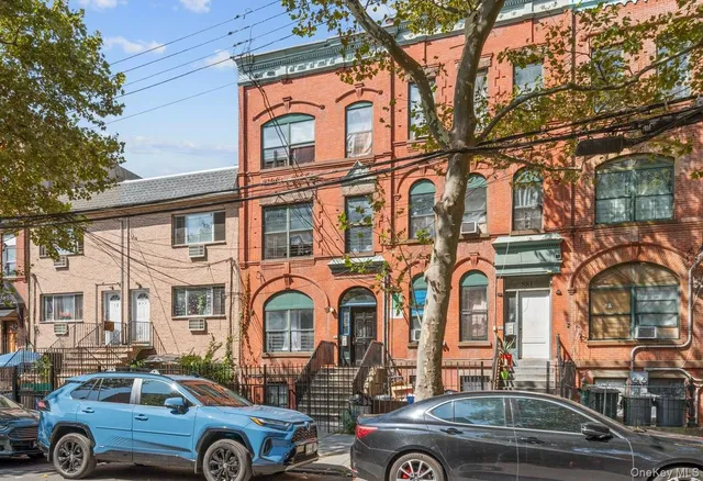 a front view of a residential apartment building with a yard