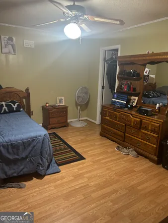 a bedroom with a bed cabinets and flat screen tv