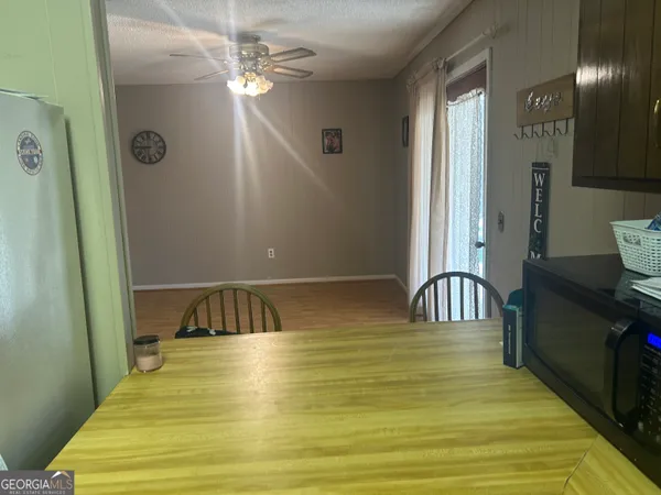 a kitchen with a sink cabinets and wooden floor