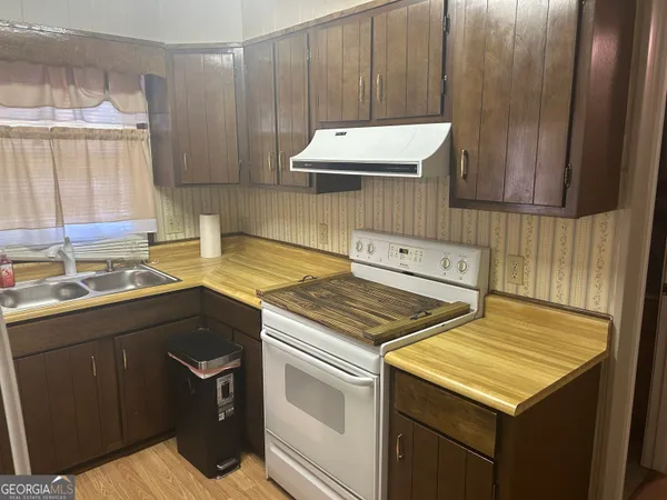 a kitchen with a sink stove and cabinets