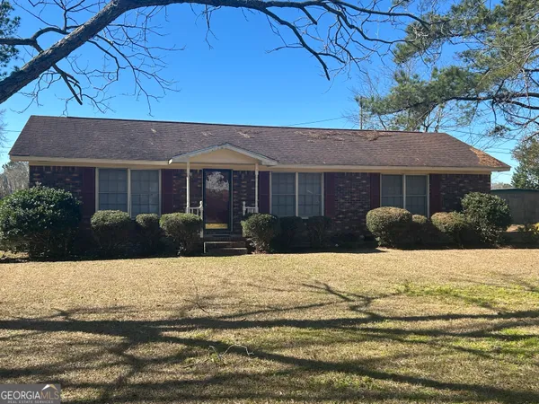 a view of a house with snow on the background
