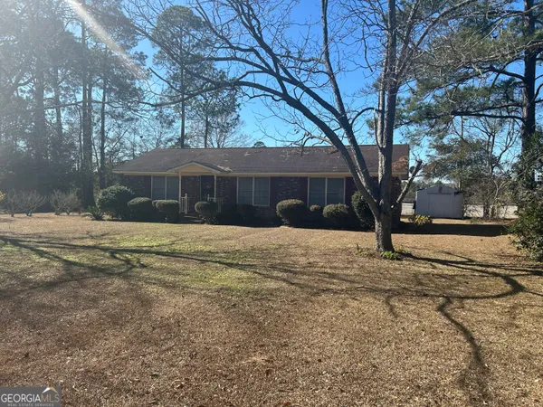 a view of a yard covered with snow in front of house