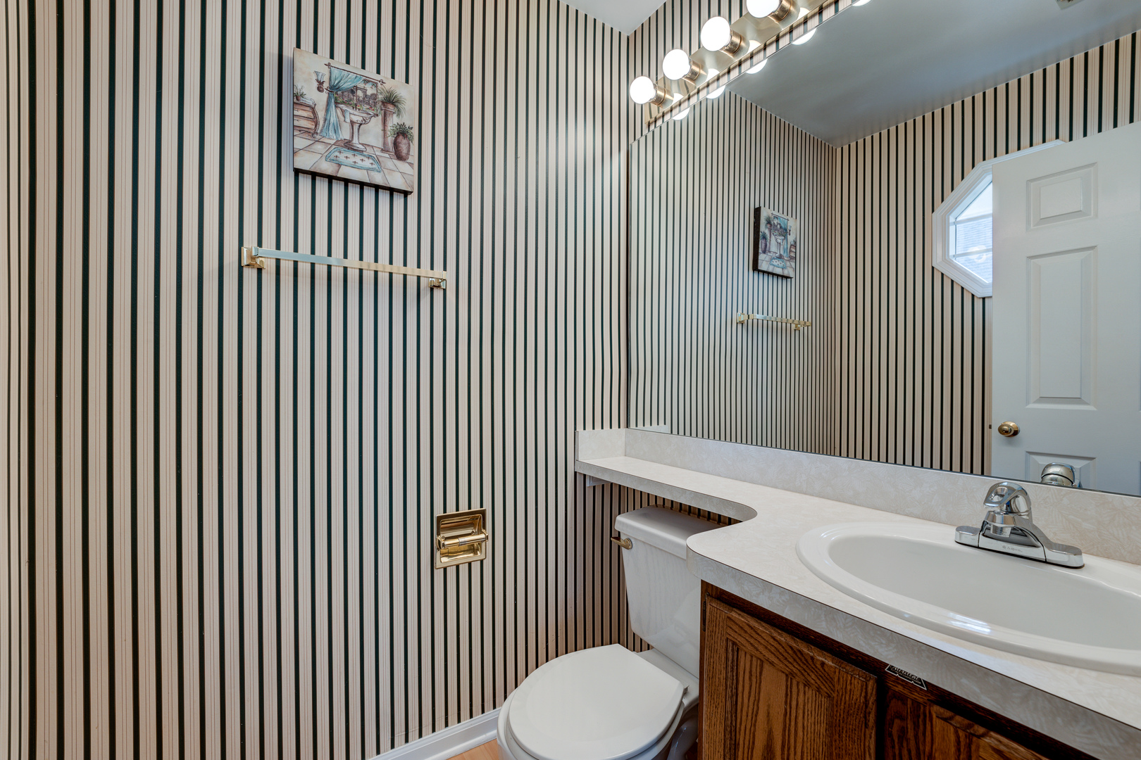 298 Ripplebrook Court Schaumburg, IL 60173 - Photo 13 of 27 a bathroom with a sink a toilet and mirror