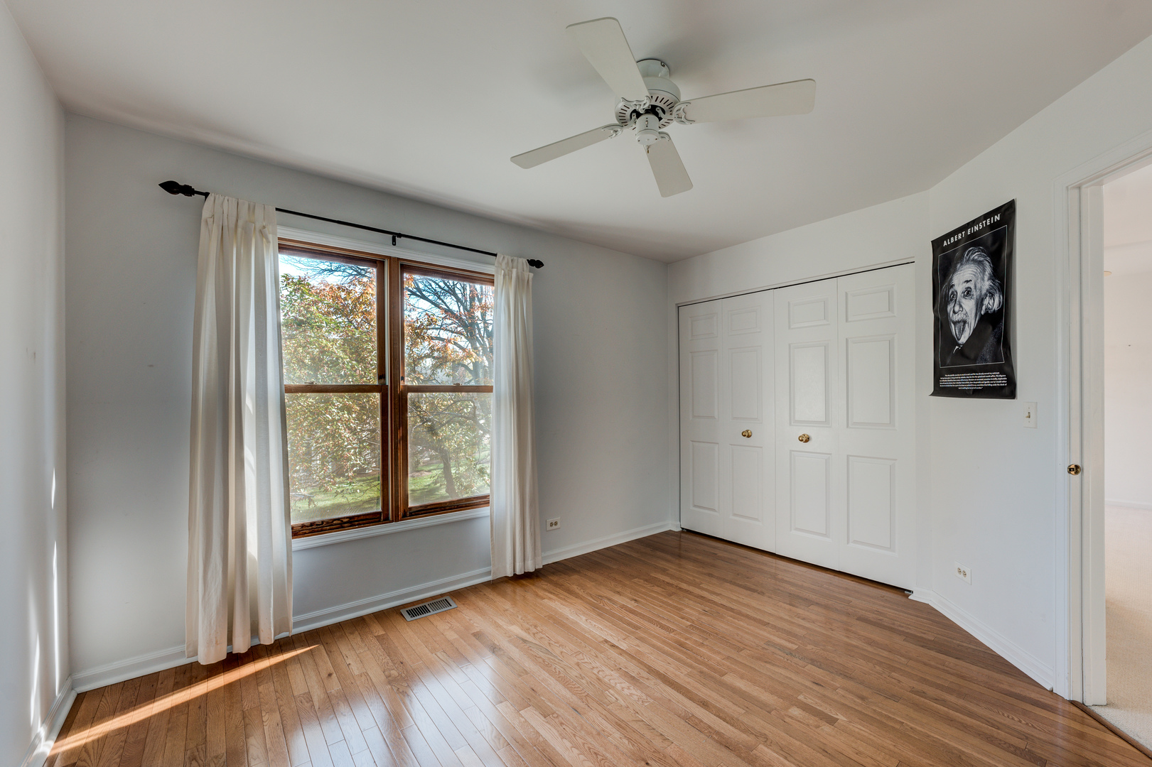 298 Ripplebrook Court Schaumburg, IL 60173 - Photo 19 of 27 a view of an empty room with a window and wooden floor
