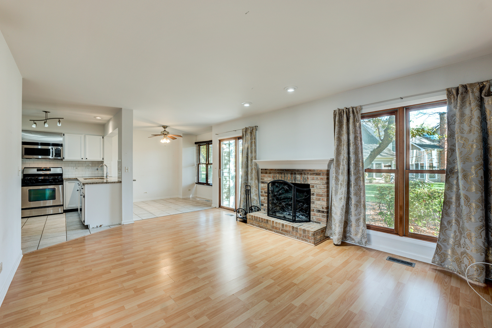 298 Ripplebrook Court Schaumburg, IL 60173 - Photo 24 of 27 an empty room with wooden floor fireplace and windows