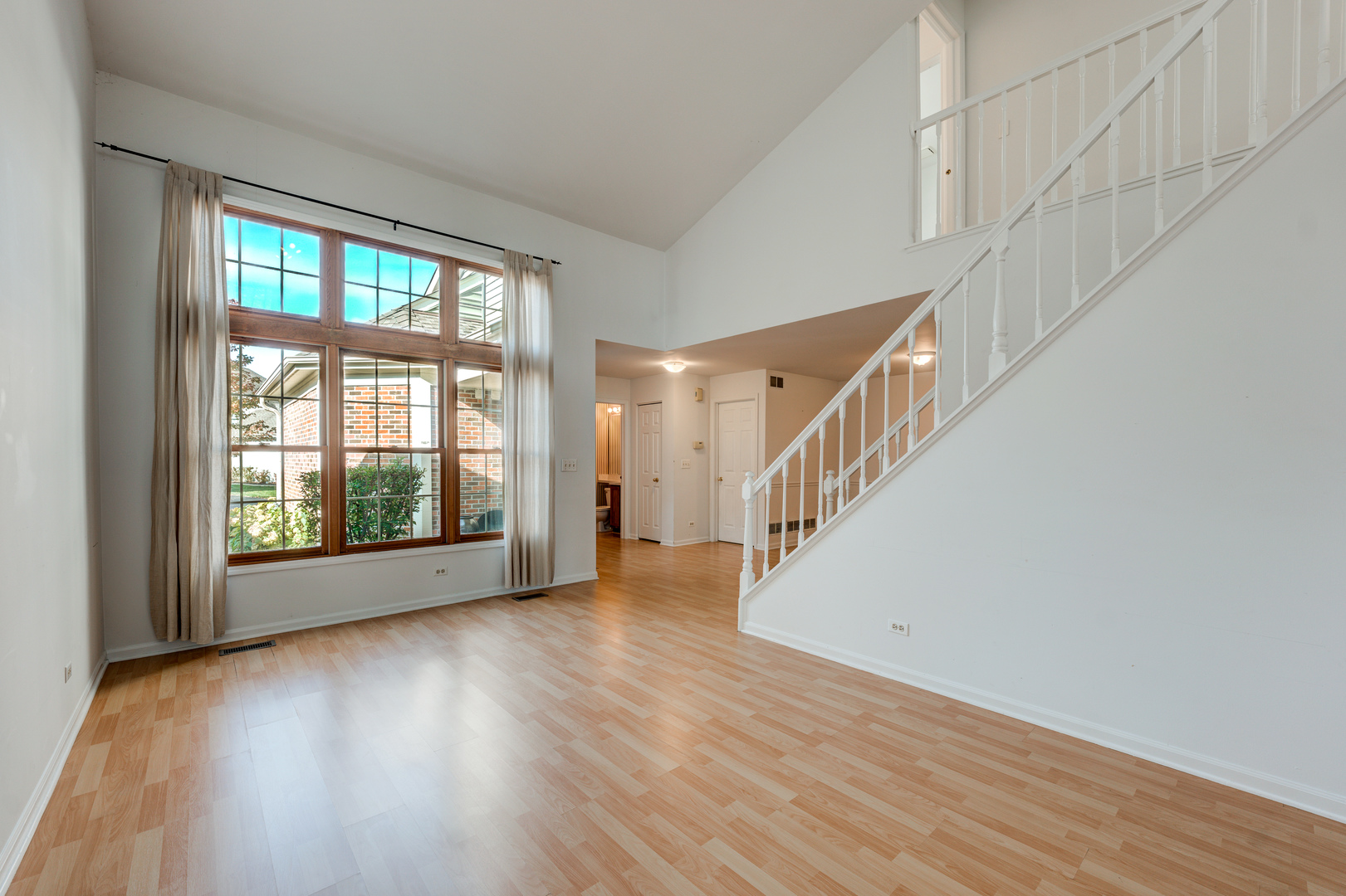298 Ripplebrook Court Schaumburg, IL 60173 - Photo 6 of 27 a view of an empty room with wooden floor and a window