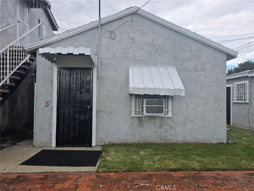 220 South Pannes Avenue, Unit 3 Compton, CA 90221 - Photo 1 of 4 a brick house with a yard