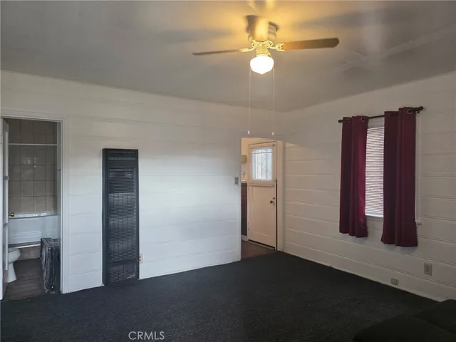 an empty room with closet and windows