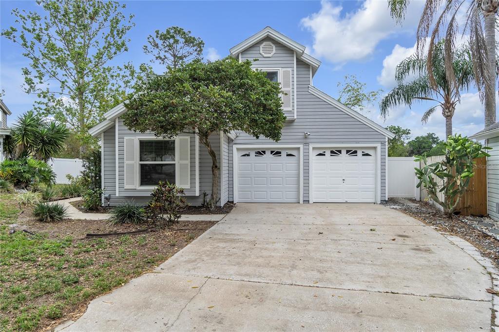 107 Pier Point Court Orlando, FL 32835 - Photo 1 of 1 a front view of a house with a yard and a garage
