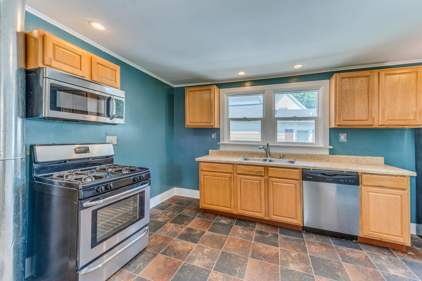 209 West Exchange Street Sycamore, IL 60178 - Photo 12 of 25 a kitchen with stainless steel appliances granite countertop a stove a sink and a microwave