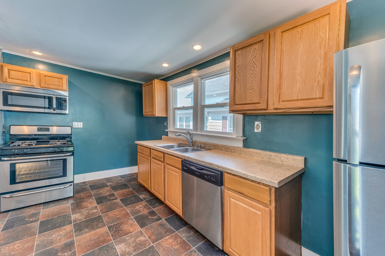 209 West Exchange Street Sycamore, IL 60178 - Photo 13 of 25 a kitchen with stainless steel appliances granite countertop a stove a sink and a refrigerator