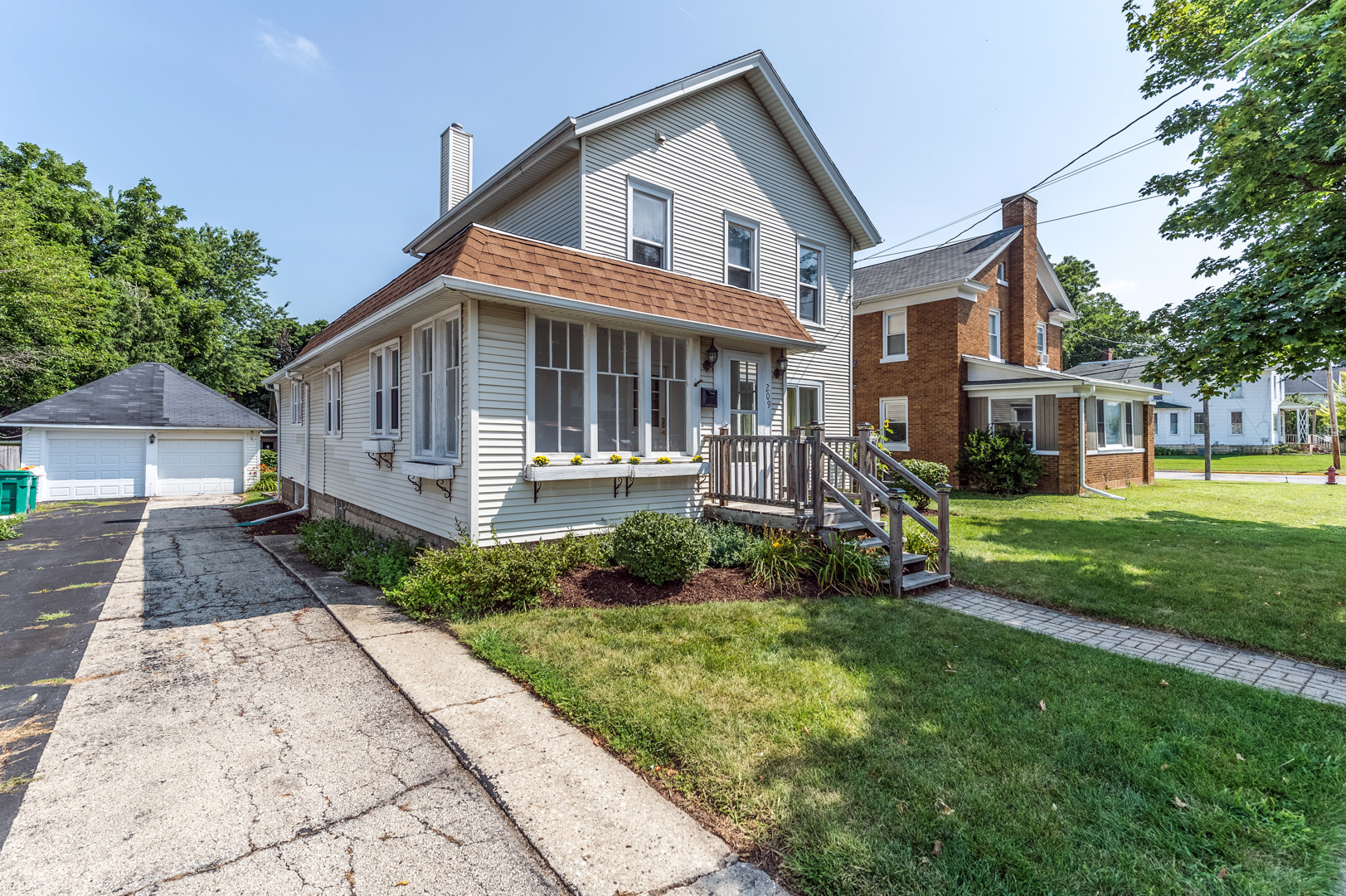 209 West Exchange Street Sycamore, IL 60178 - Photo 2 of 25 a front view of a house with a yard and potted plants