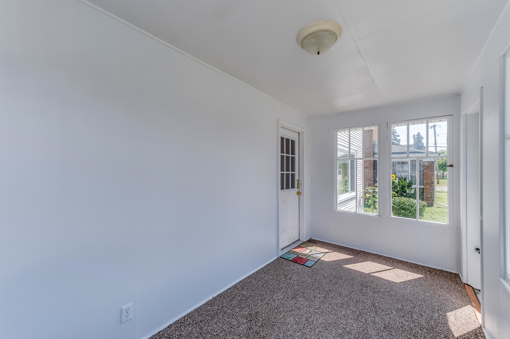 209 West Exchange Street Sycamore, IL 60178 - Photo 3 of 25 a view of empty room with windows