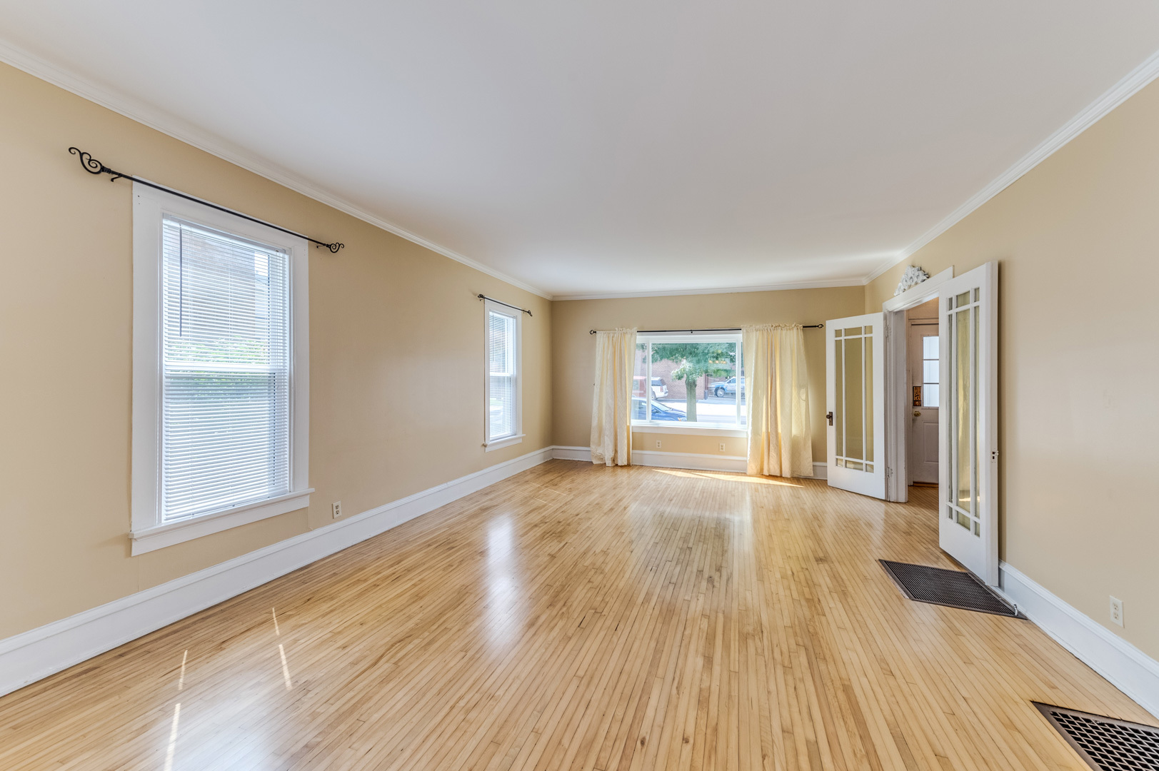 209 West Exchange Street Sycamore, IL 60178 - Photo 6 of 25 a view of an empty room with wooden floor and a window