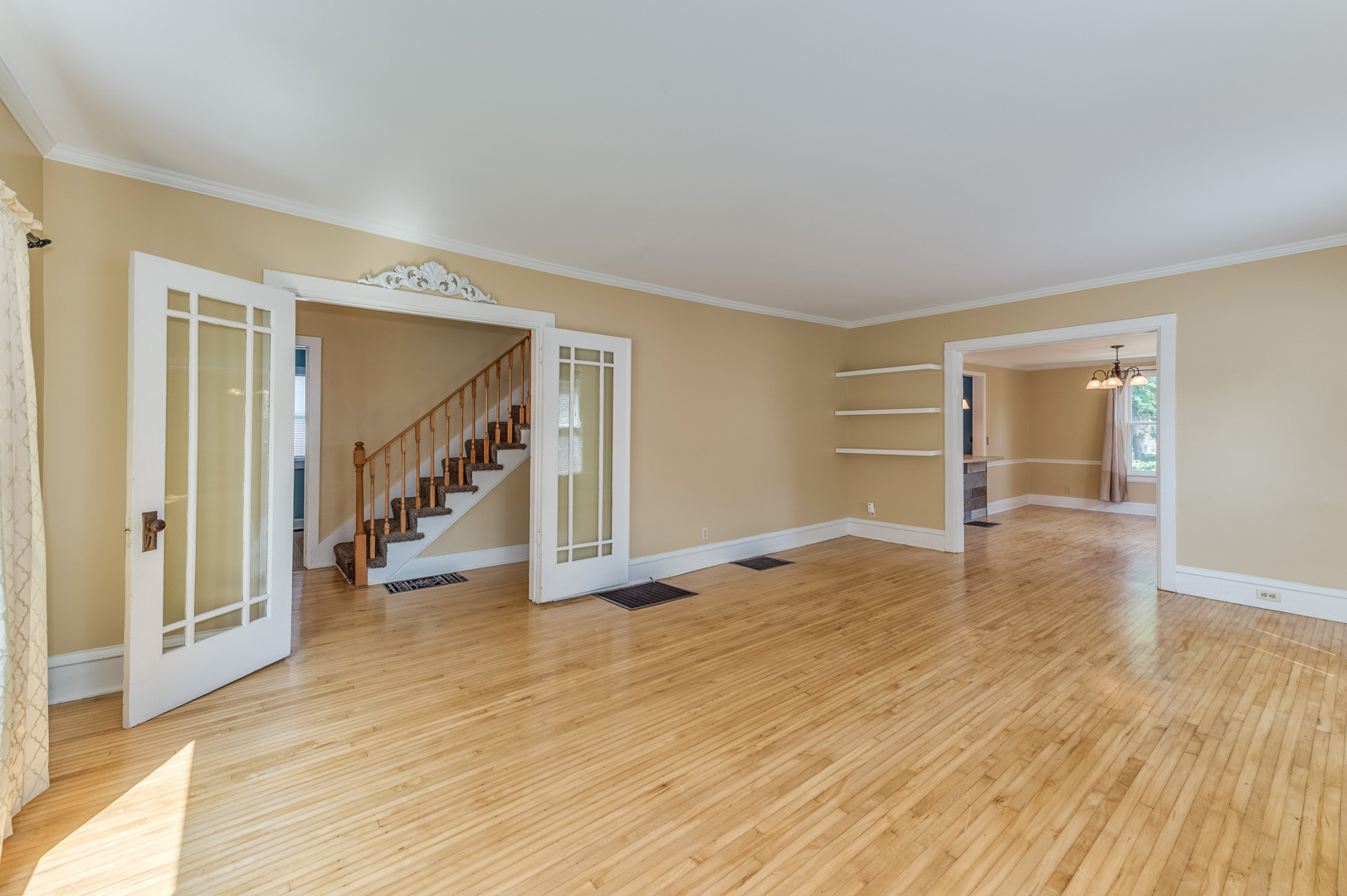 209 West Exchange Street Sycamore, IL 60178 - Photo 7 of 25 a view of an empty room with wooden floor and stairs