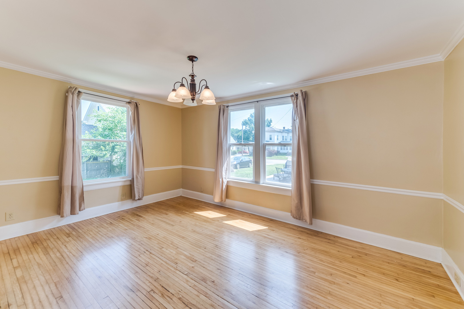 209 West Exchange Street Sycamore, IL 60178 - Photo 8 of 25 an empty room with wooden floor and windows