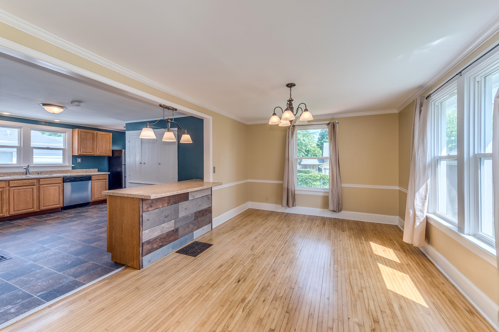 209 West Exchange Street Sycamore, IL 60178 - Photo 9 of 25 a large living room with a large window wooden floor and furniture
