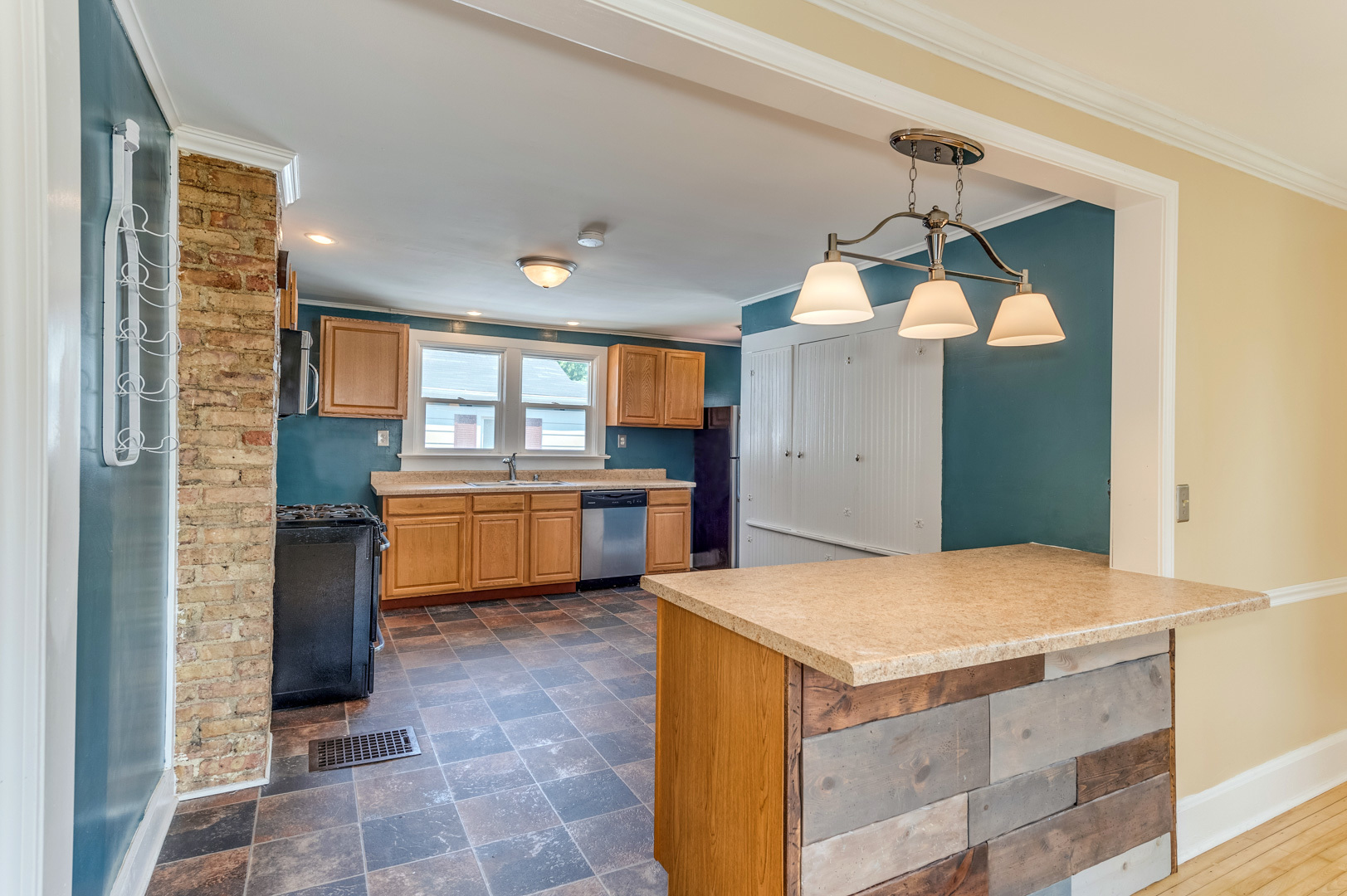 209 West Exchange Street Sycamore, IL 60178 - Photo 10 of 25 a kitchen with a sink a counter top space cabinets and stainless steel appliances