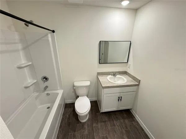 a bathroom with a toilet a sink and bathtub