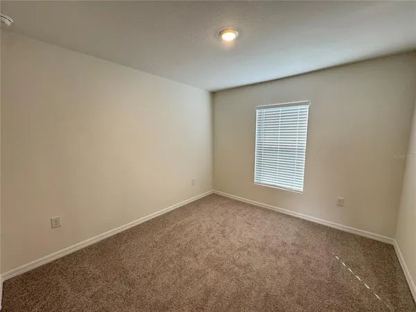 a view of an empty room and closet area