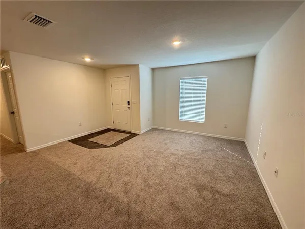 a large white kitchen with a stove a sink dishwasher and a refrigerator
