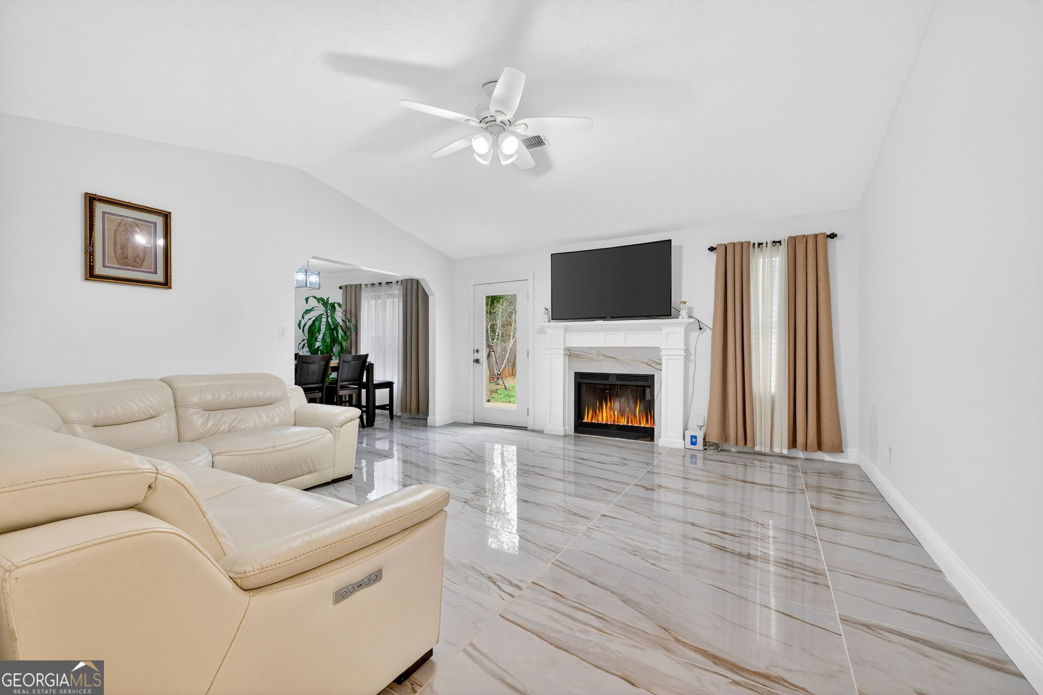 1589 Bonanza Church Road Hampton, GA 30228 - Photo 4 of 28 a living room with furniture a fireplace and a flat screen tv