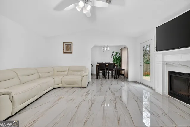 a living room with furniture a fireplace and a flat screen tv