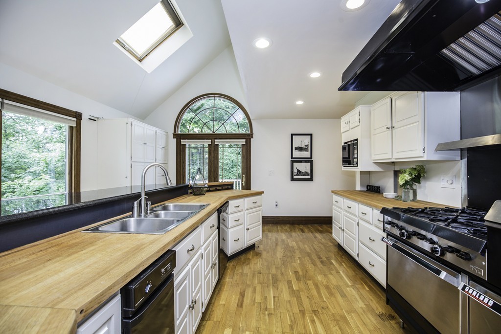 57 Oak Ridge Road Boxford, MA 01921 - Photo 11 of 30 a kitchen with stainless steel appliances a sink a stove and a wooden floors