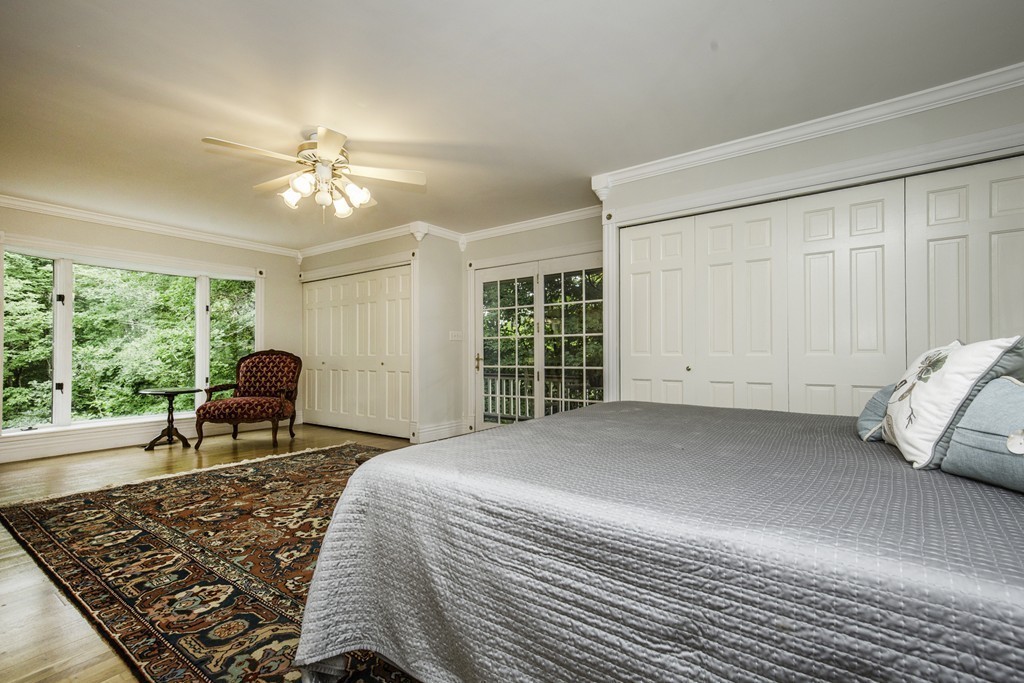 57 Oak Ridge Road Boxford, MA 01921 - Photo 14 of 30 a bedroom with a bed and glass door