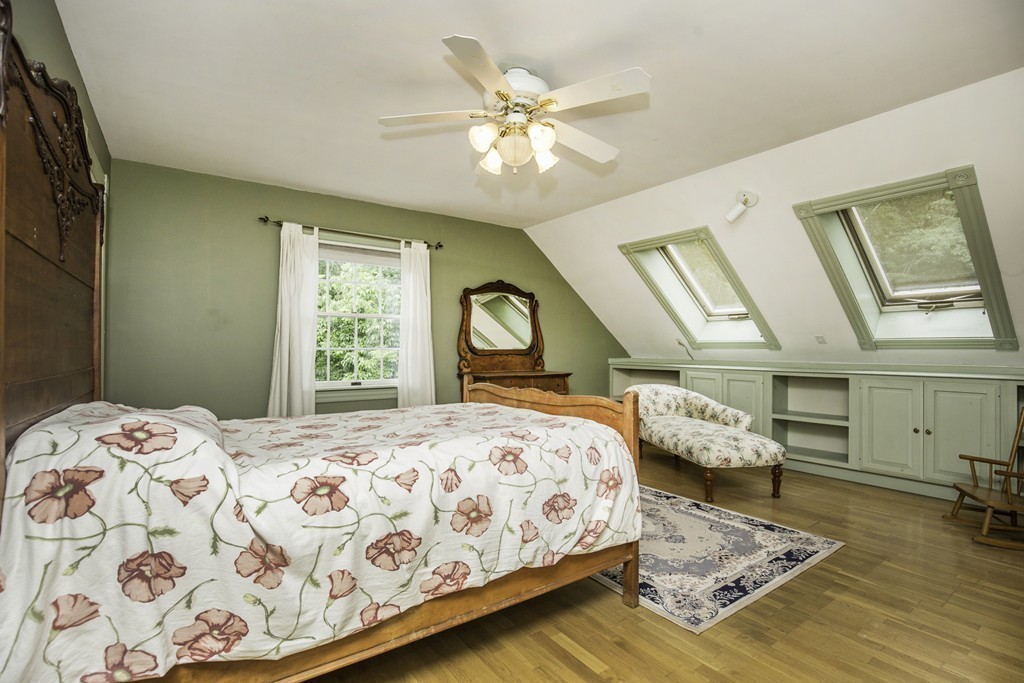 57 Oak Ridge Road Boxford, MA 01921 - Photo 16 of 30 a bedroom with a bed and a chandelier