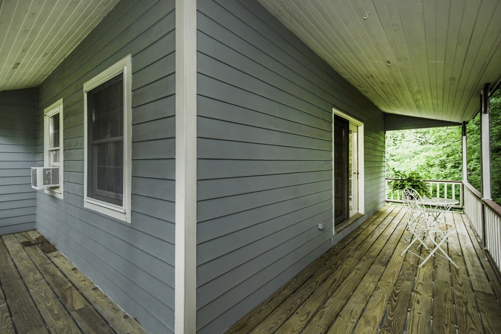 57 Oak Ridge Road Boxford, MA 01921 - Photo 21 of 30 a view of backyard with wooden deck and floor to ceiling window