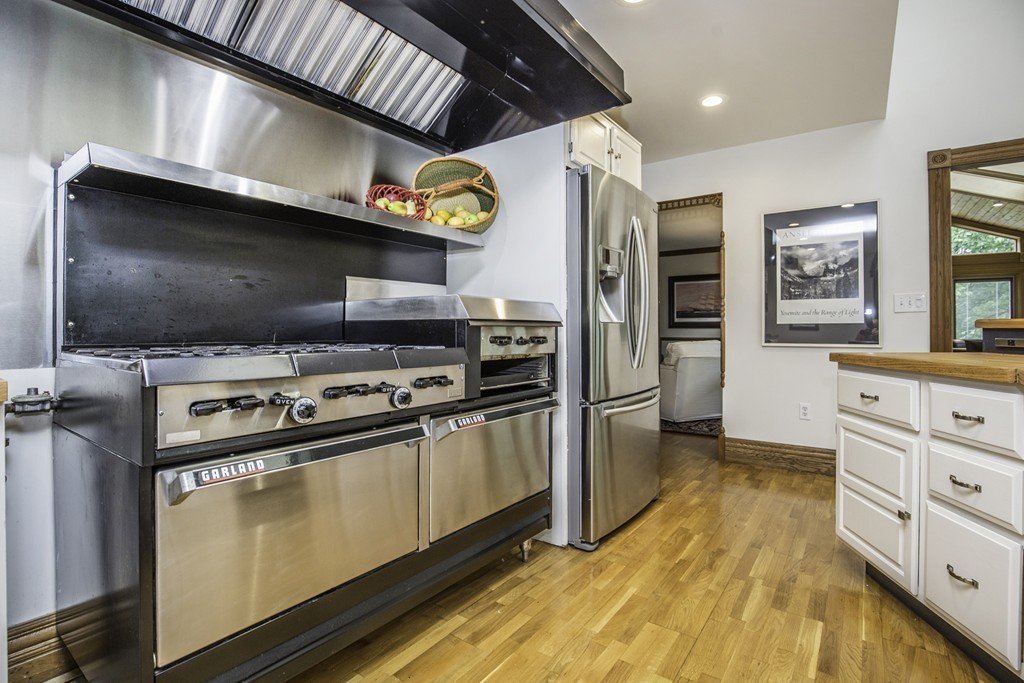 57 Oak Ridge Road Boxford, MA 01921 - Photo 10 of 30 a kitchen with stainless steel appliances a stove a microwave and a refrigerator