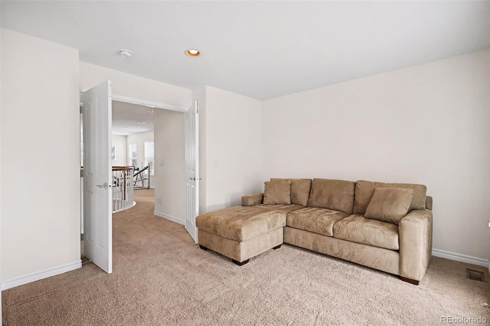 10844 Huntwick Street Highlands Ranch, CO 80130 - Photo 15 of 29 a living room with furniture and a bathroom