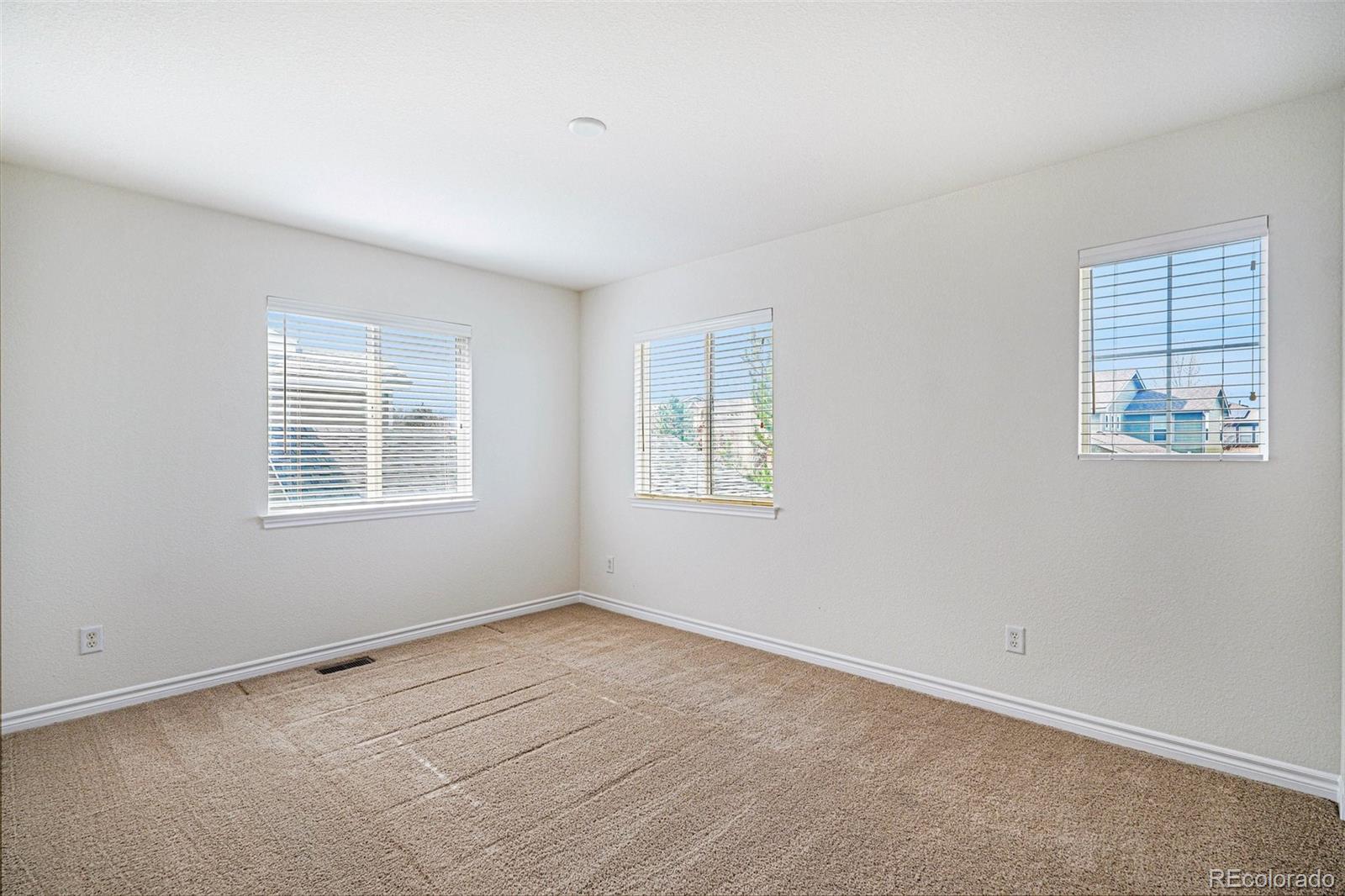 10844 Huntwick Street Highlands Ranch, CO 80130 - Photo 20 of 29 an empty room with windows