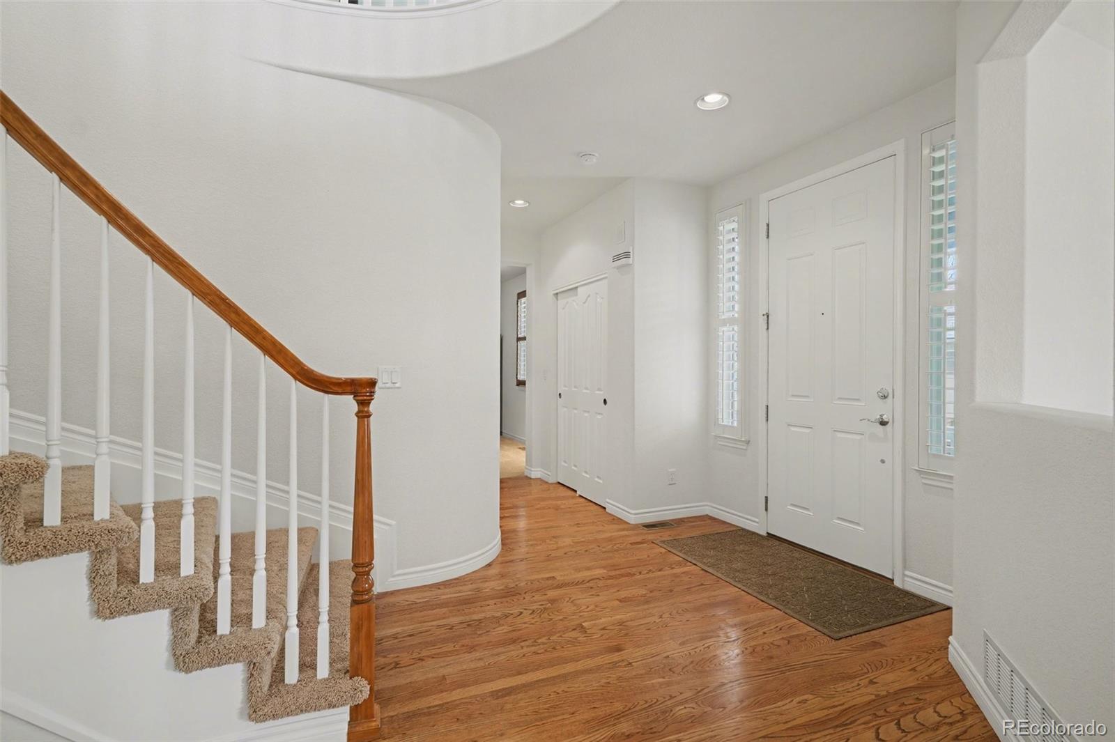 10844 Huntwick Street Highlands Ranch, CO 80130 - Photo 3 of 29 a view of an empty room with wooden floor