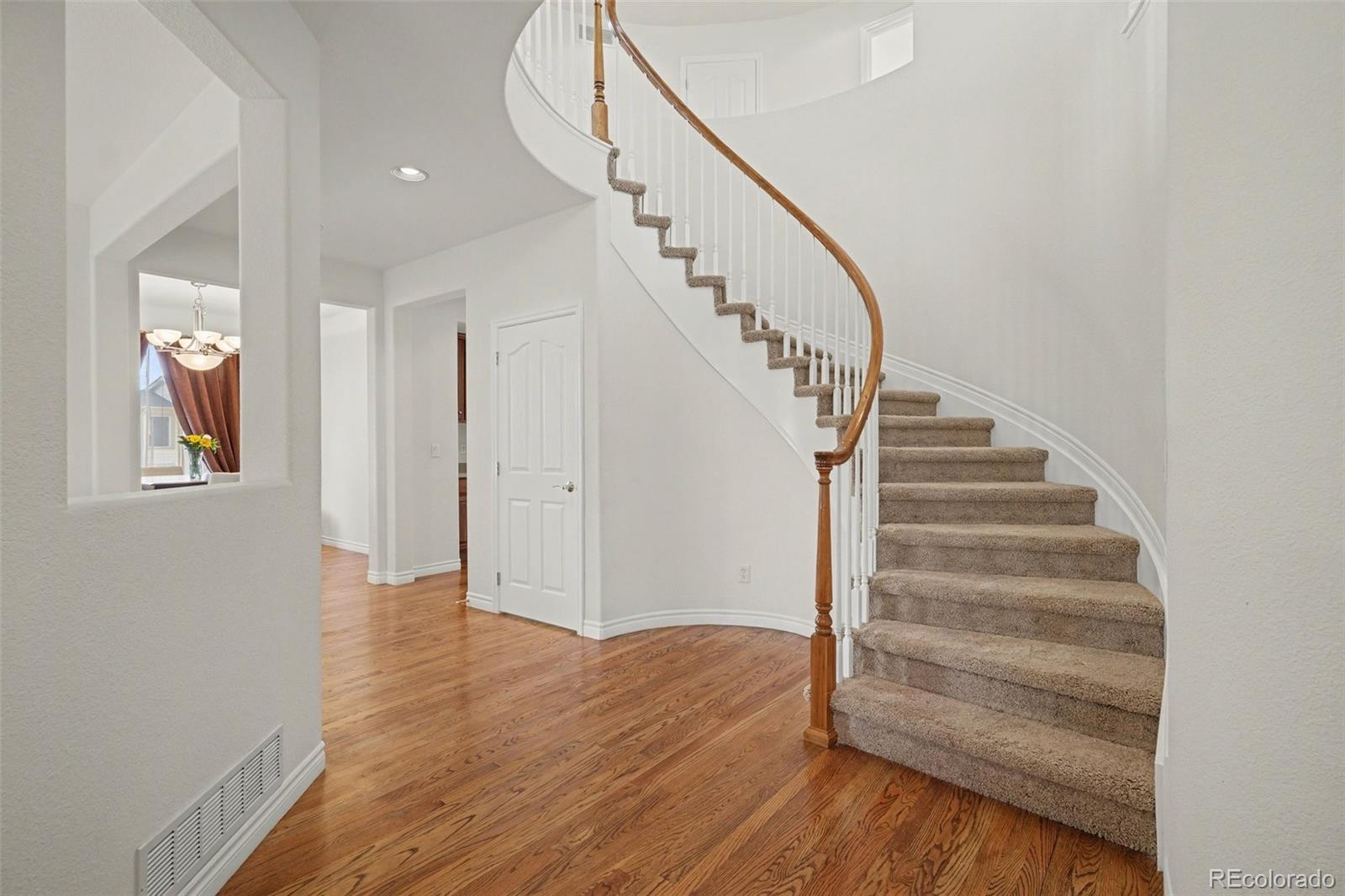 10844 Huntwick Street Highlands Ranch, CO 80130 - Photo 4 of 29 a view of entryway and hall with wooden floor